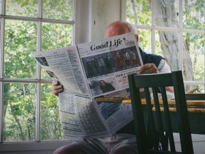 Older adult reading a newspaper